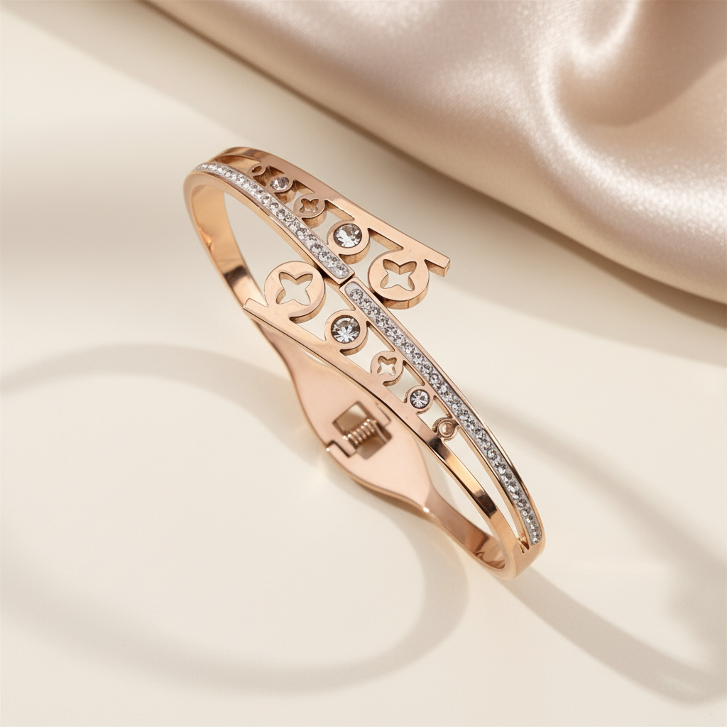 Rose gold bracelet with diamond accents on a beige fabric background