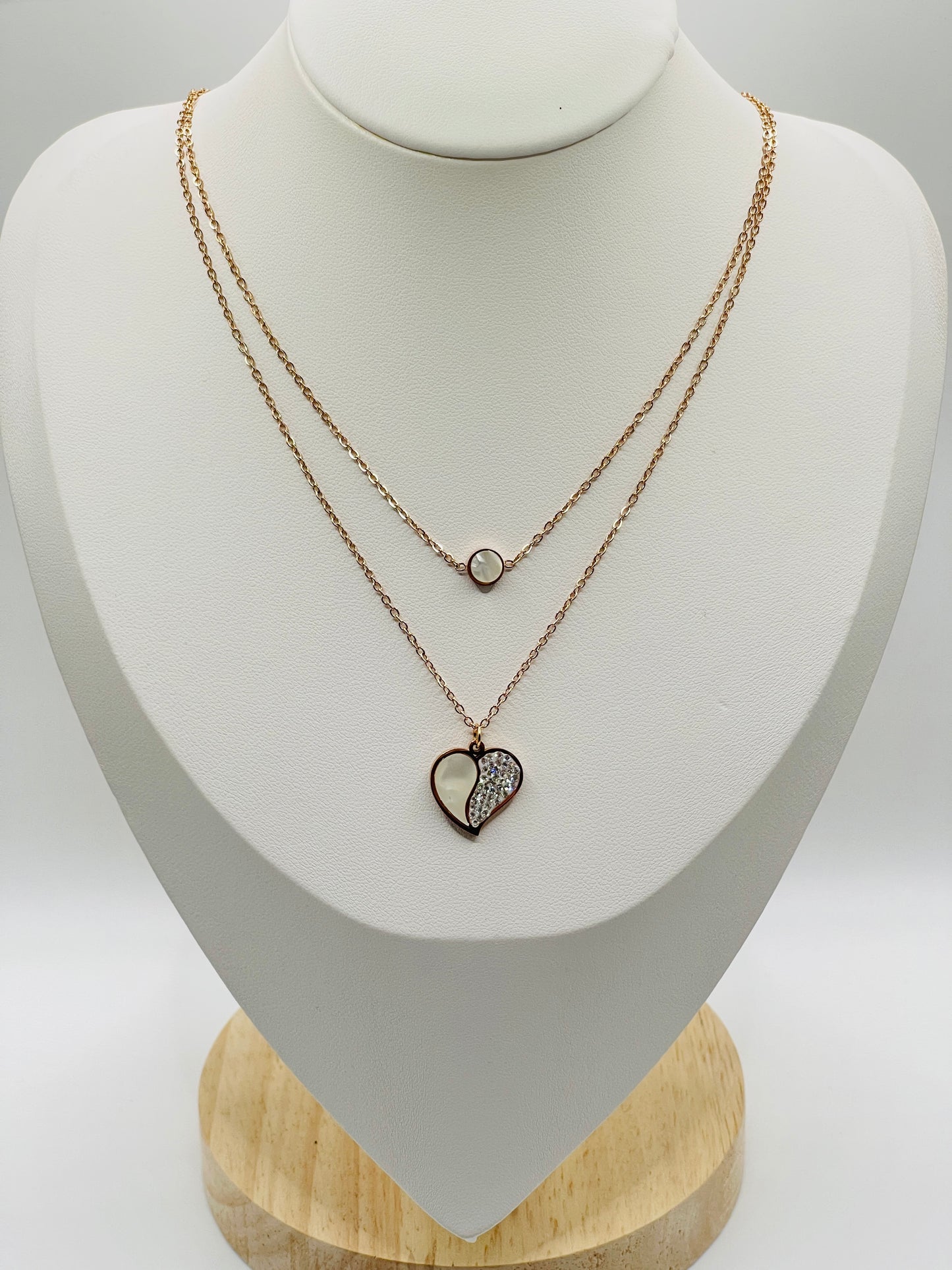 Necklace with heart-shaped pendant on a mannequin bust against a white background