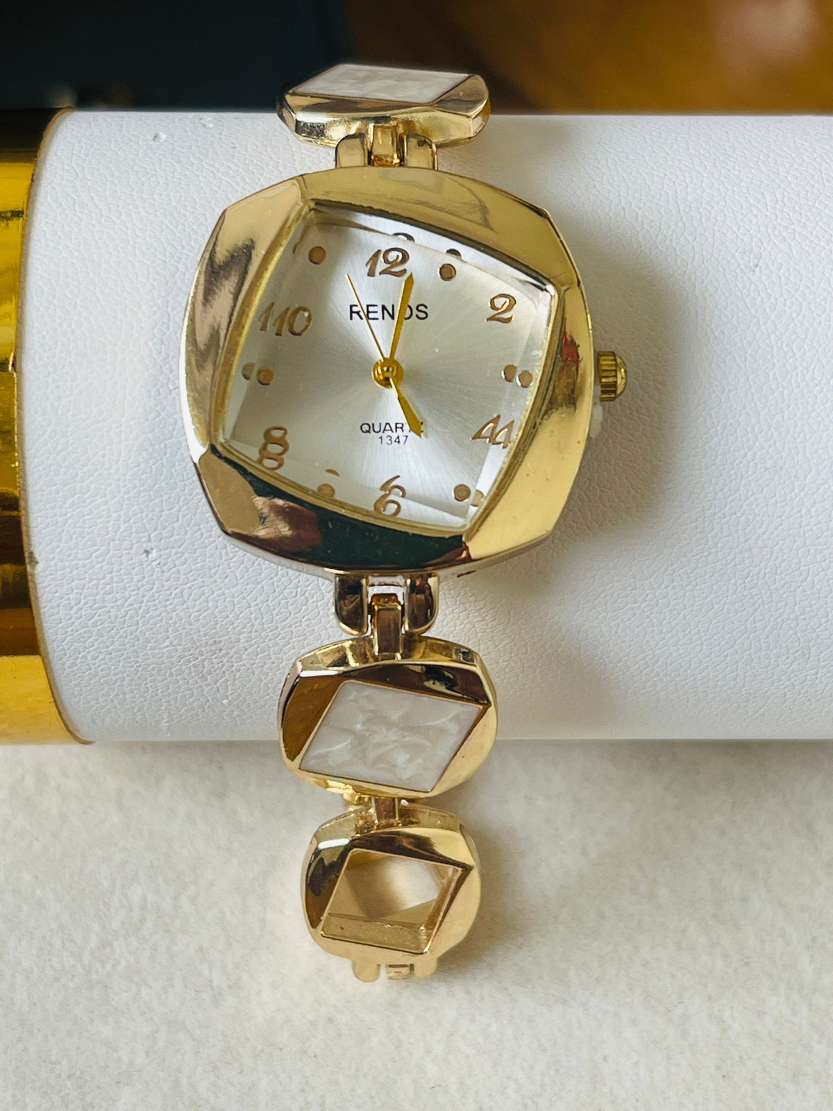 Renos Quartz 1347 gold bracelet watch with white pearl dial and stone links