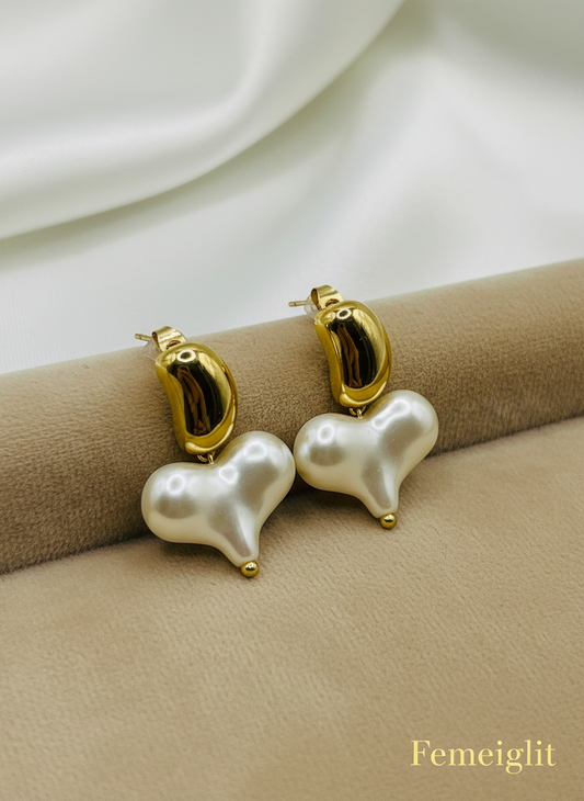 Pearl earrings with gold accents on a white surface