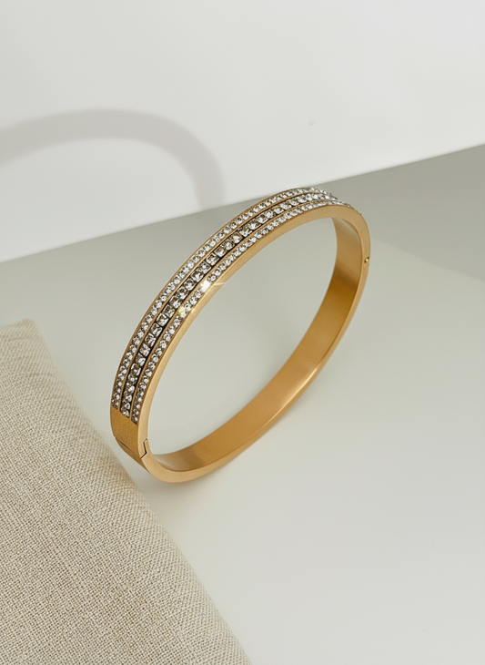 Rose Gold bracelet with embedded stones on a light background