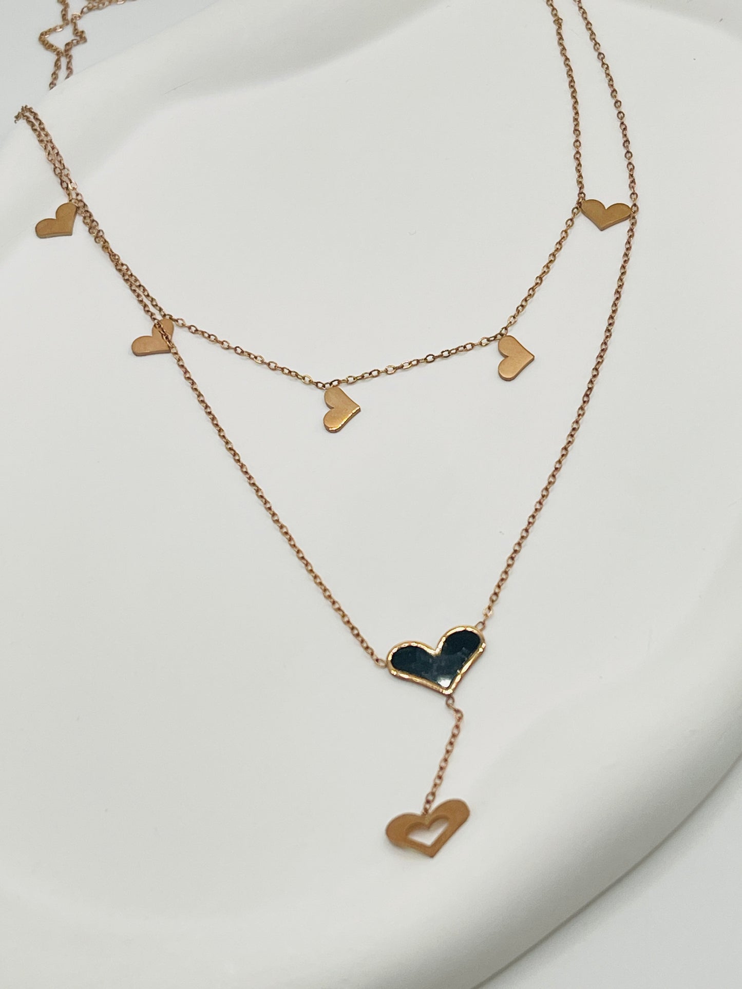 Rose Gold heart-shaped necklace on a white background