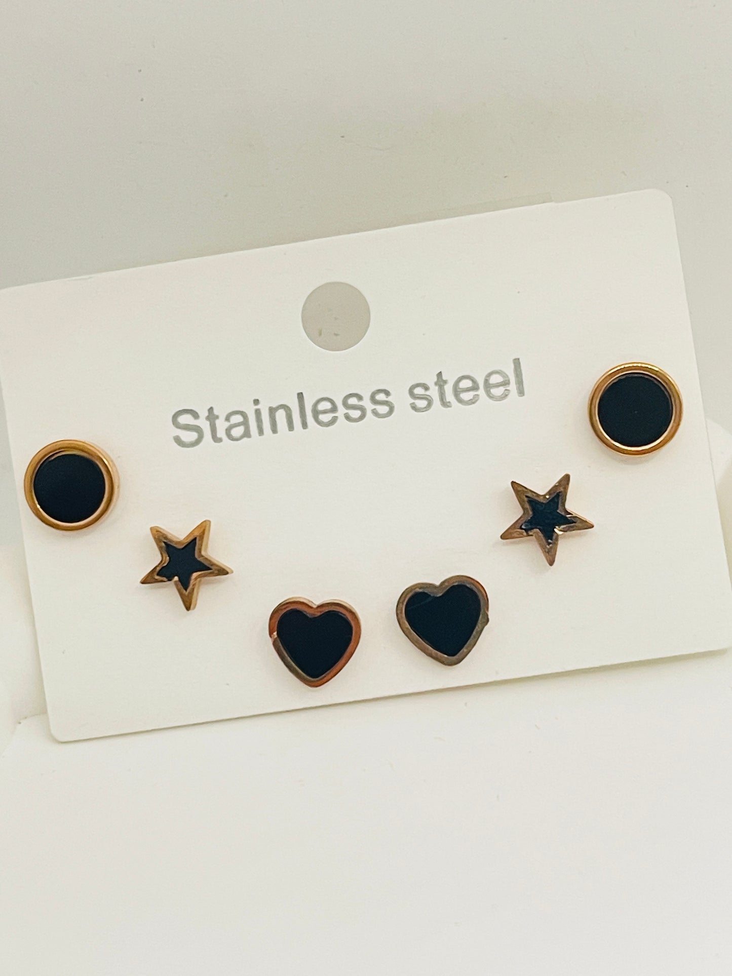 Set of stainless steel earrings on a white card with 'Stainless steel' text.