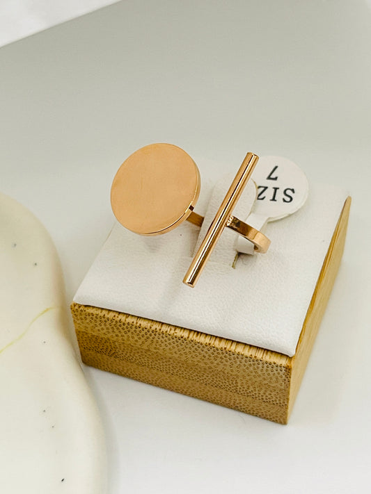Rose Gold cufflinks on a marble surface with a gold box