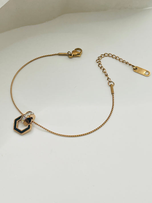 Rose Gold bracelet with hexagonal charm on a white background