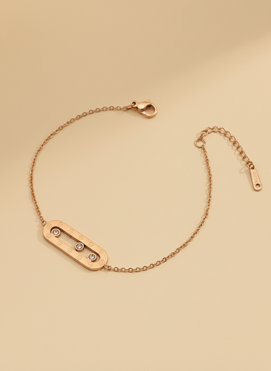 Rose gold bracelet with three small diamonds on a beige background