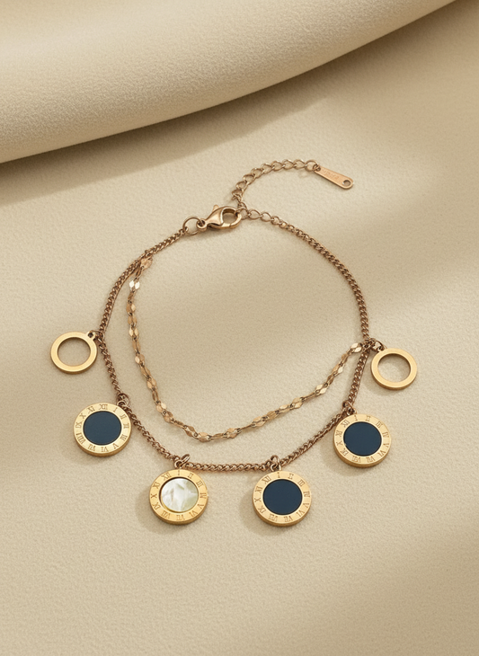 Rose Gold bracelet with circular charms on a beige background