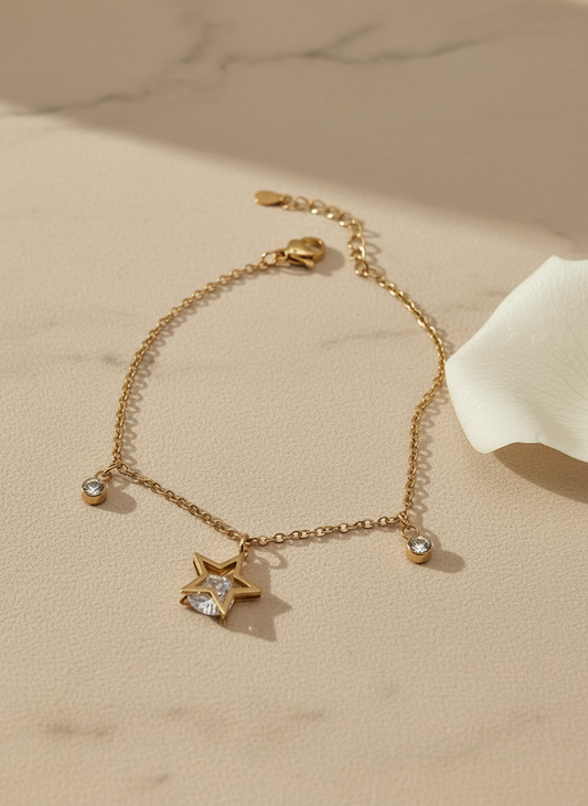 rose Gold bracelet with star and heart charms on a beige surface