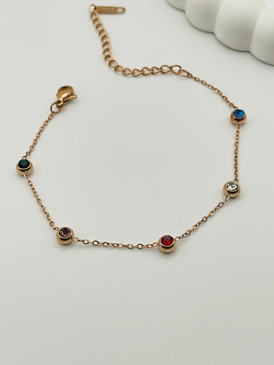 Rose Gold bracelet with gemstones on a white background