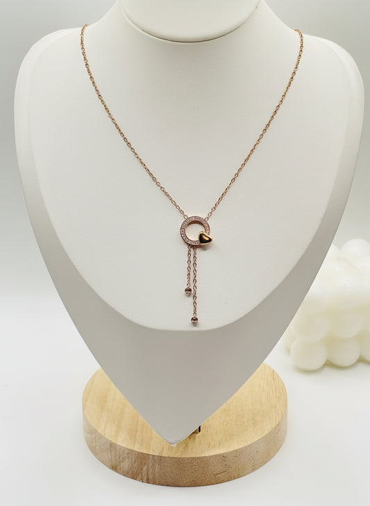 Rose gold necklace on a white mannequin bust with a wooden base.