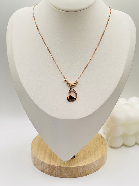 Rose gold Necklace with a heart-shaped pendant on a white mannequin bust