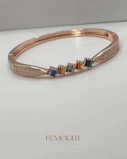Rose gold bracelet with colorful beads on a white surface, featuring the brand 'Femeiglit'.
