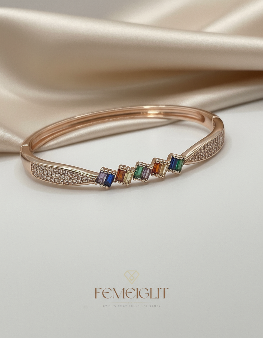 Rose gold bracelet with colorful stones on a satin surface, featuring the brand 'Femeiglit'.
