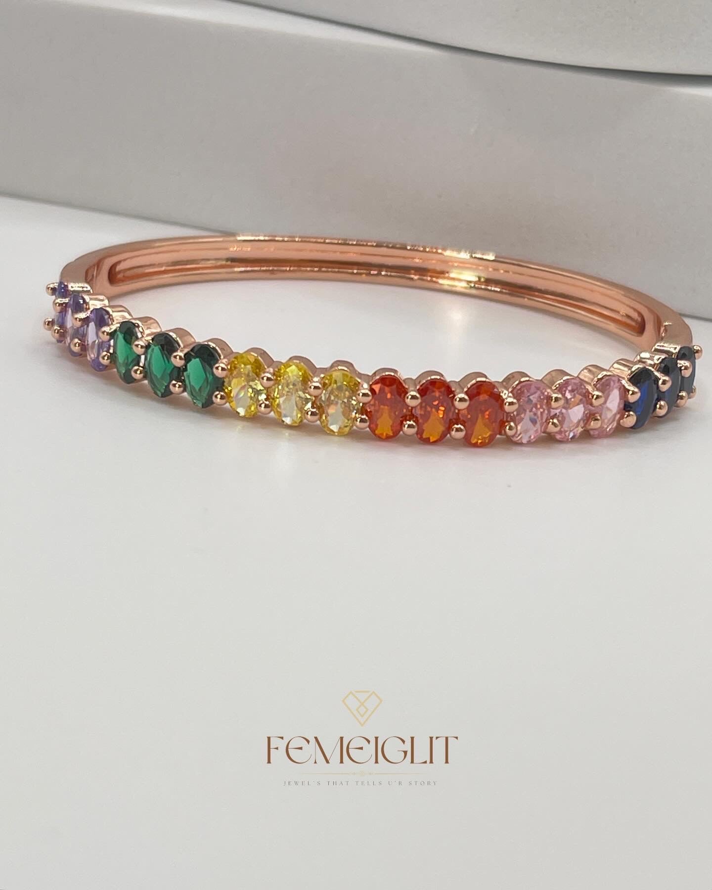 Multicolored gemstone bracelet on a white background with 'Femeiglit' branding.