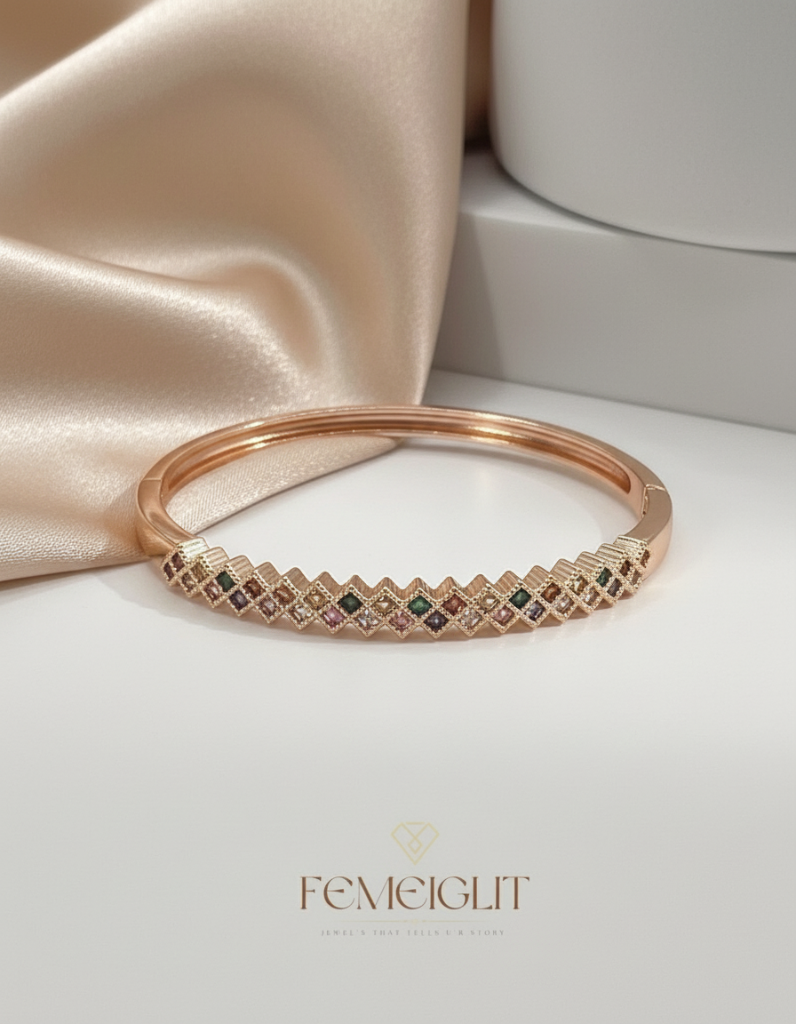 Rose gold bracelet with gemstones on a satin surface, featuring the brand 'Femeiglit'.