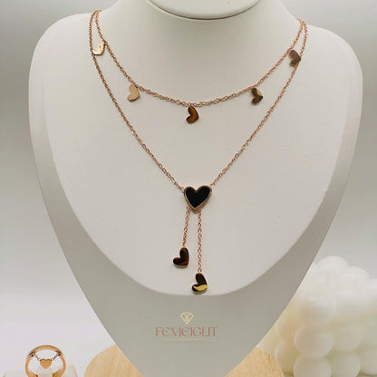 Rose gold Necklace with heart-shaped pendants on a mannequin bust, featuring the brand 'Femeiglit'.