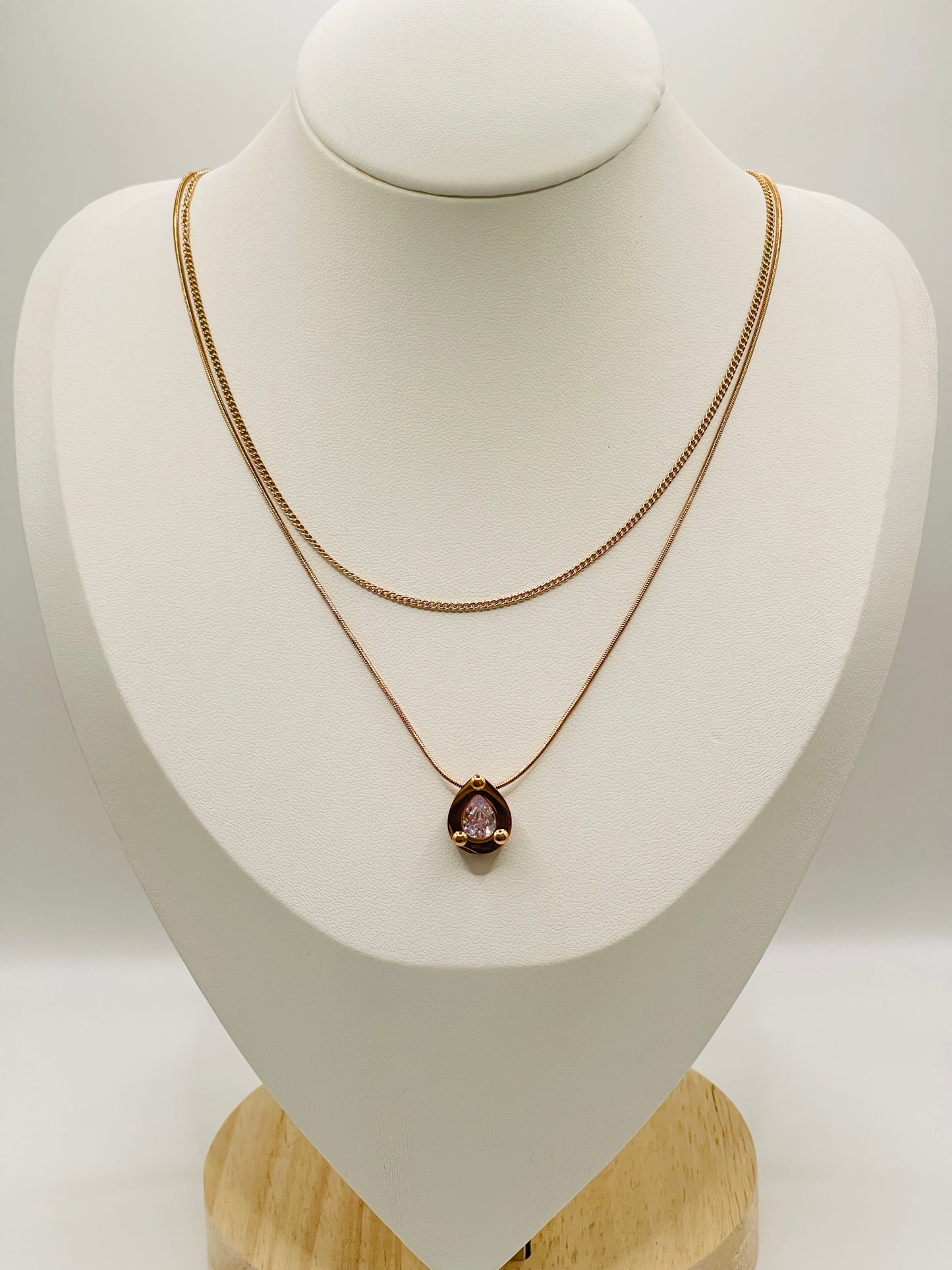 Rose Gold necklace with a pendant on a mannequin bust against a white background