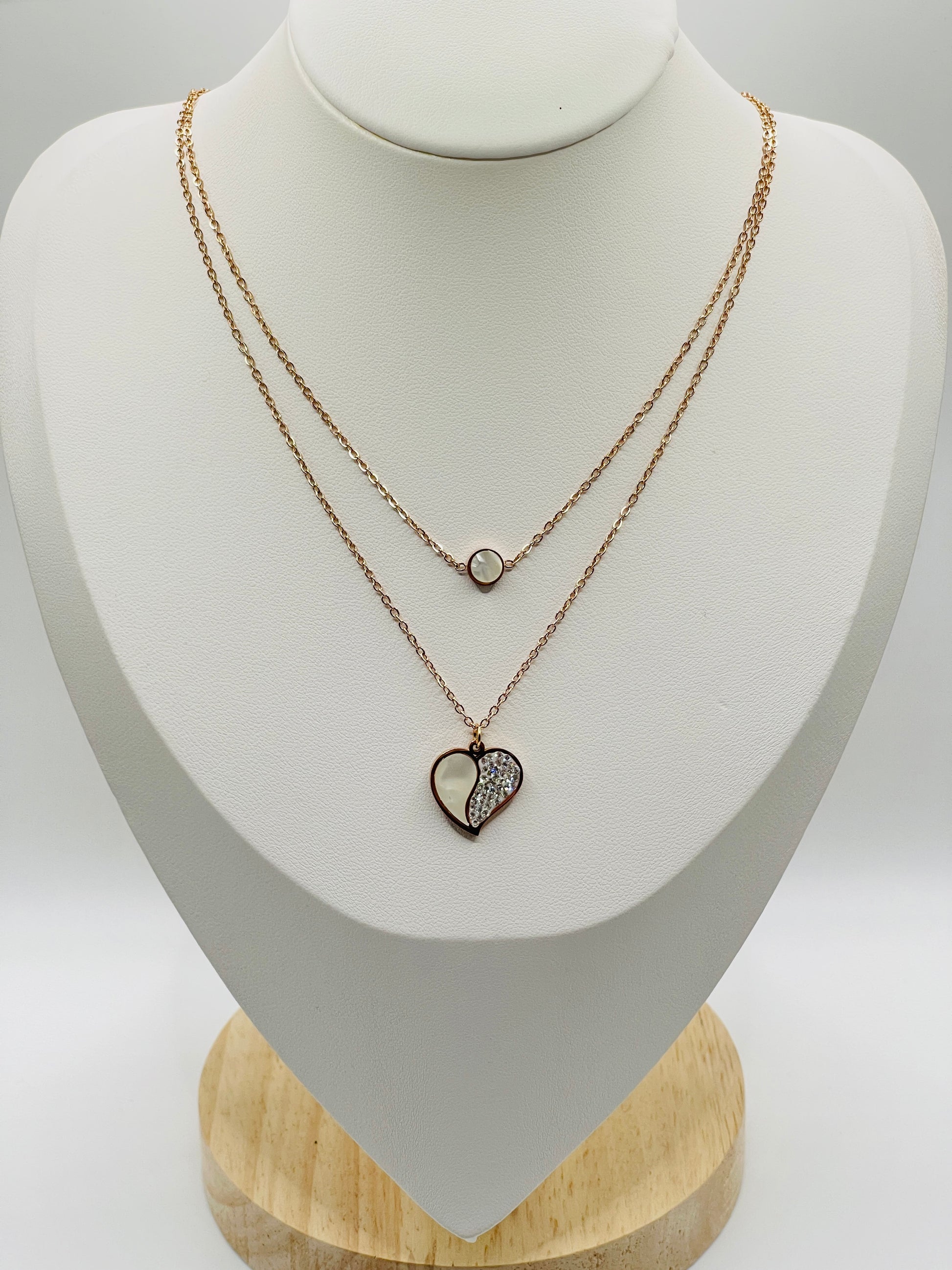 Necklace with heart-shaped pendant on a mannequin bust against a white background
