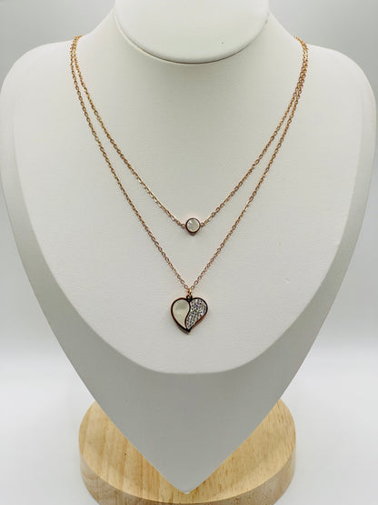Necklace with heart-shaped pendant on a mannequin bust against a white background
