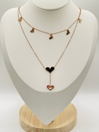 Rose gold Necklace with heart-shaped pendants on a white mannequin bust