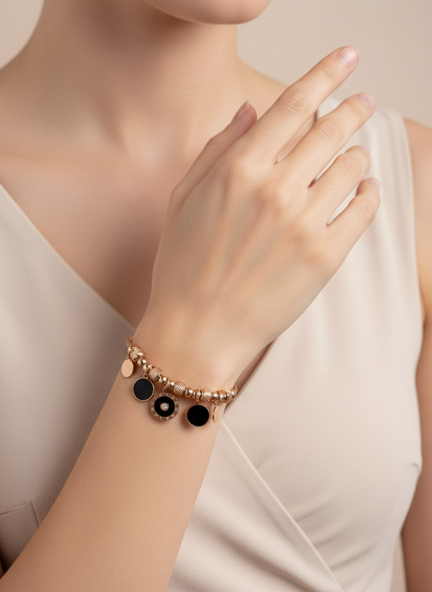 Bracelet with black beads on a wrist against a neutral background