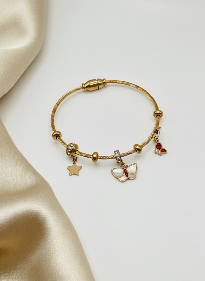 Rose Gold bracelet with charms on a beige fabric background