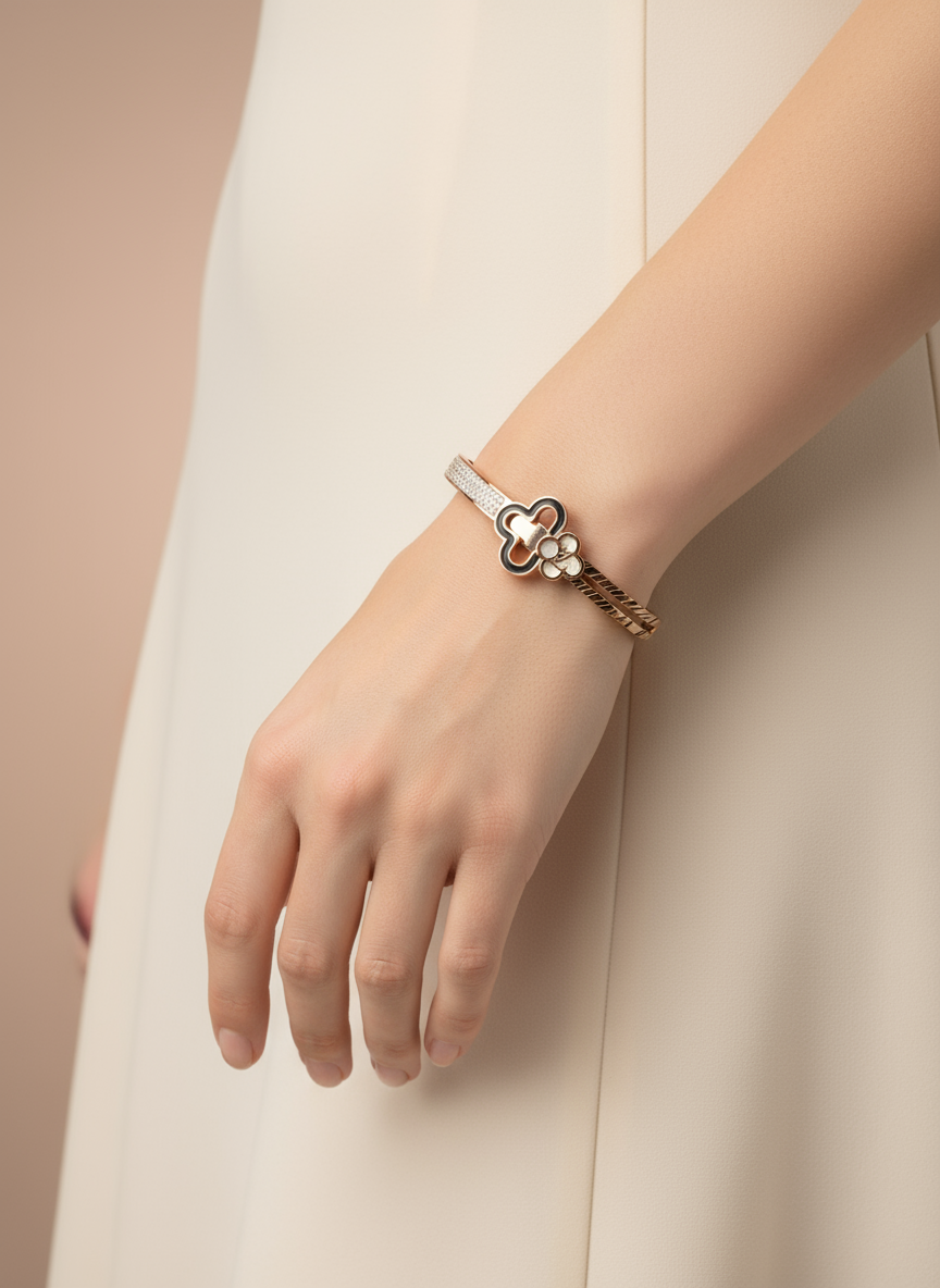 Hand wearing a bracelet with a floral design on a beige background