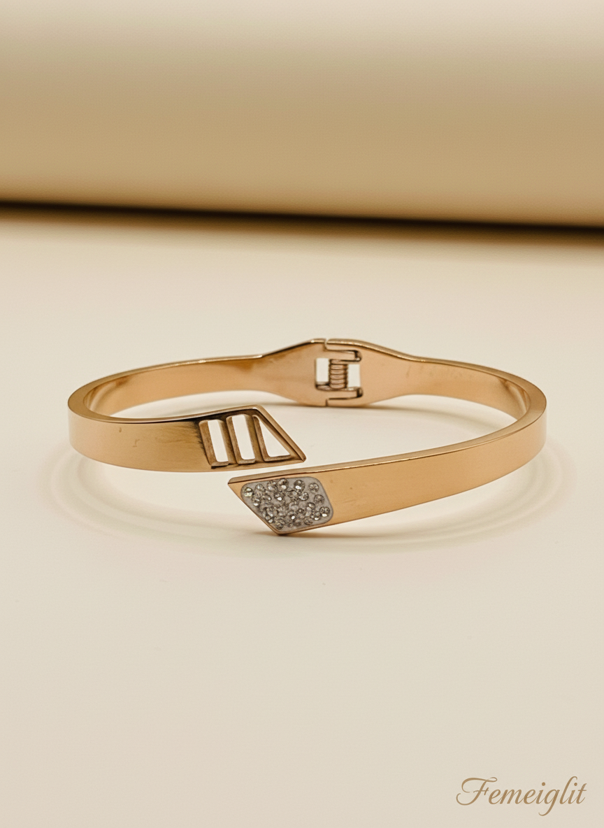 Rose gold bracelet with diamond accents on a beige background