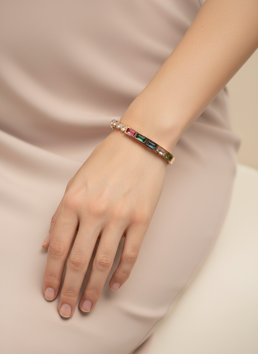 Bracelet with colorful stones on a hand against a soft pink background