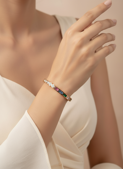 Close-up of a hand wearing a colorful  rose gold bracelet on a neutral background