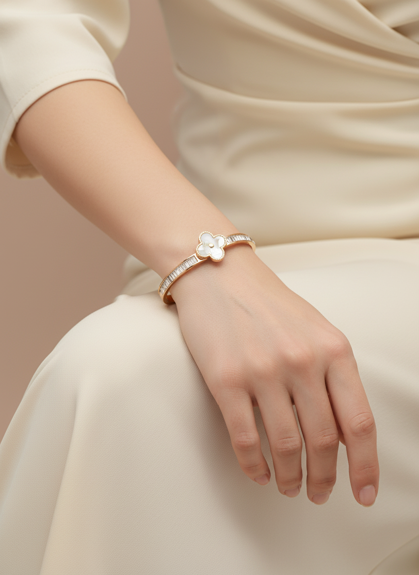 Rose Gold bracelet with a clover-shaped center and diamond accents on a beige fabric background