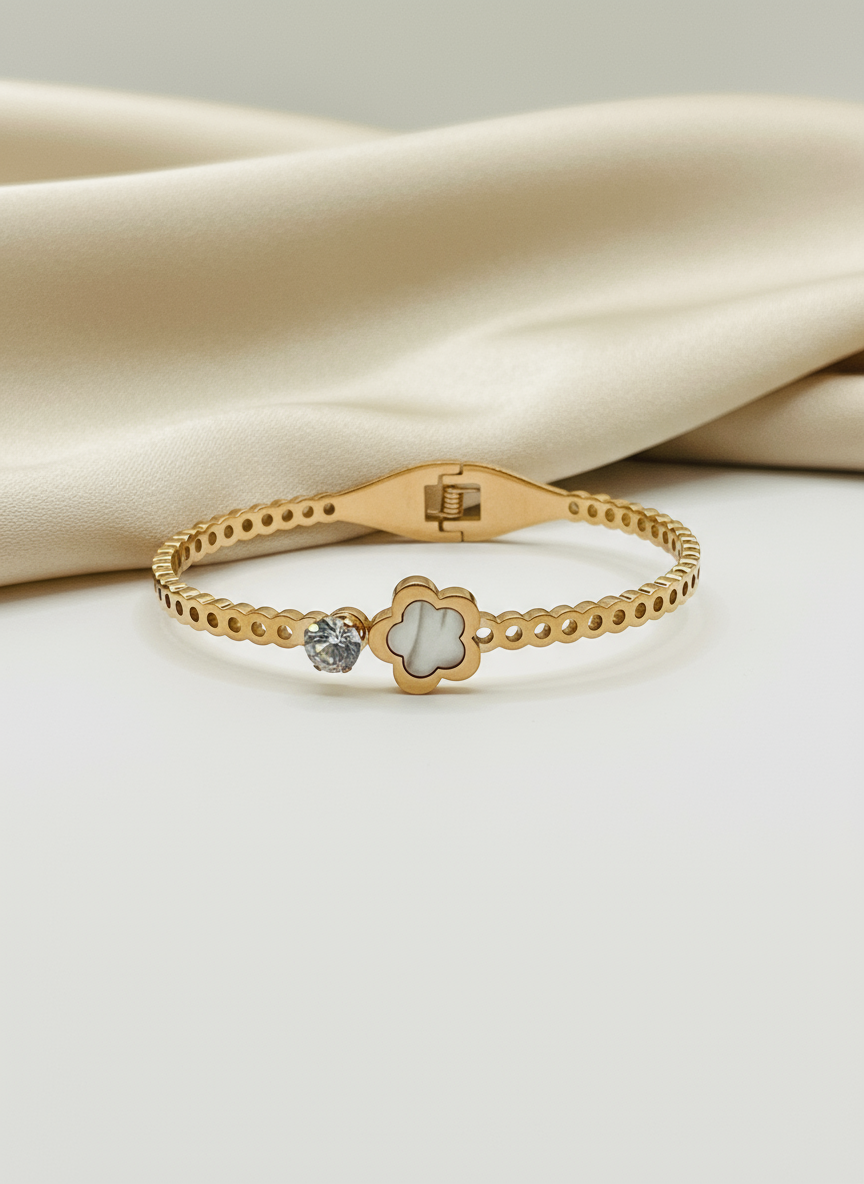 Rose Gold bracelet with a decorative clasp on a beige fabric background