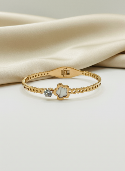 Rose Gold bracelet with a decorative clasp on a beige fabric background