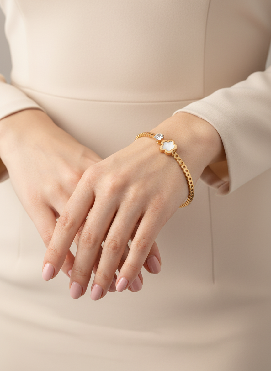 Rose Gold bracelet on a person's wrist with a neutral background