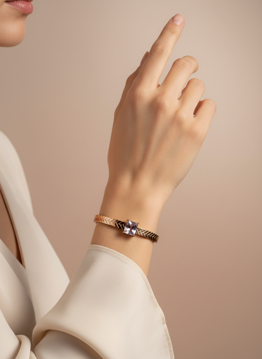 Rose Gold bracelet with a square gemstone on a white background