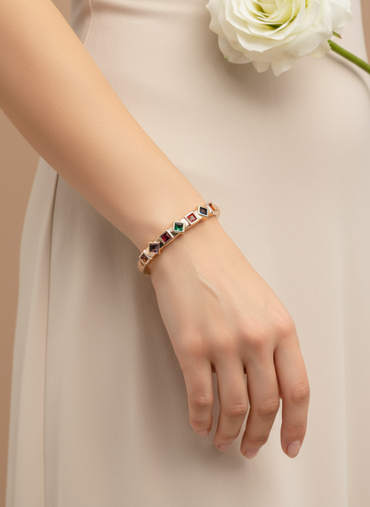 Bracelet with gemstones on a wrist against a neutral background