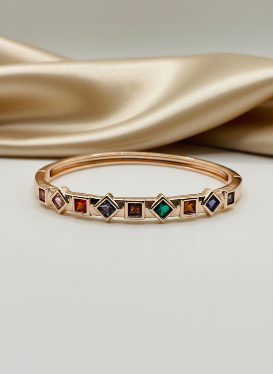 Rose Gold bracelet with colorful gemstones on a soft fabric background