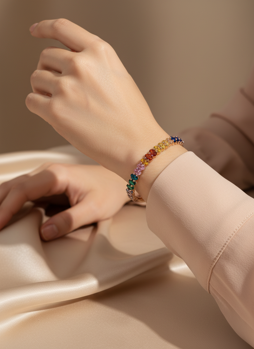 Hand wearing a colorful beaded bracelet on a neutral background