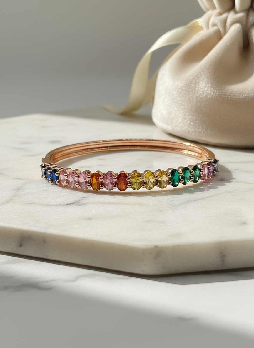 Multicolored gemstone bracelet on a marble surface with a beige drawstring bag in the background.