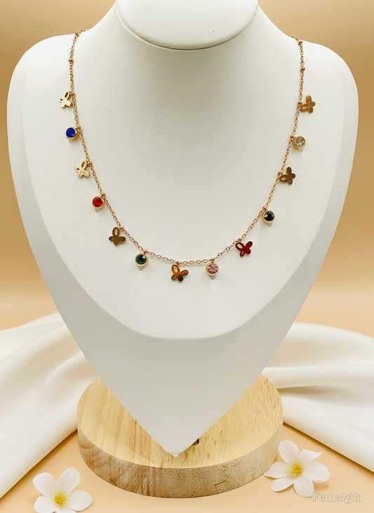 Necklace with colorful charms on a mannequin bust against a beige background