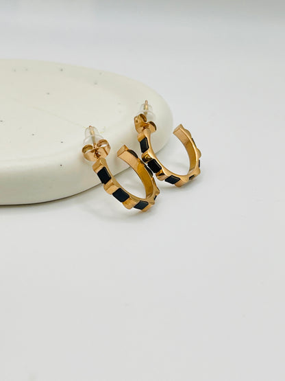 Rose Gold hoop earrings with black square pattern on a white surface