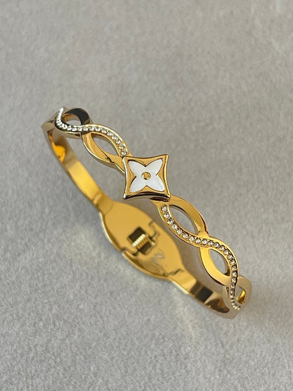 18K Gold Plated Fleur Bangle with white enamel flower centrepiece and crystal pavé infinity links