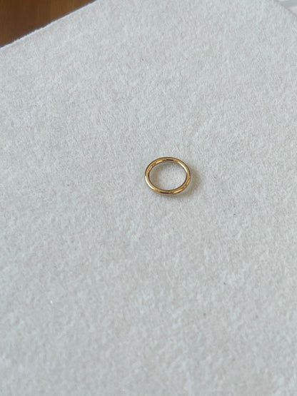 Plain seamless 18K gold nose ring 1.2x8mm flat lay showing clean circular design on white background
