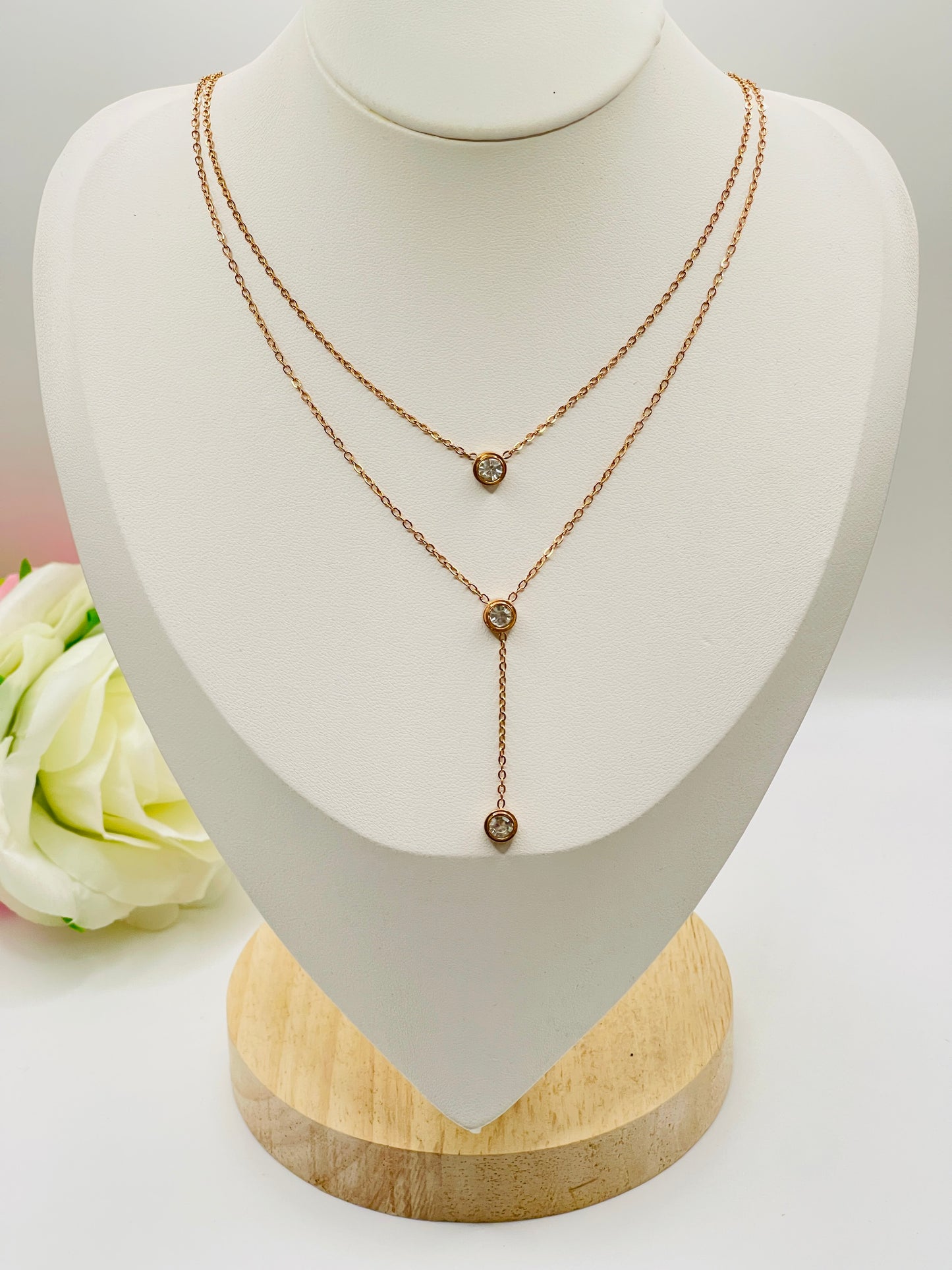 Rose Gold necklace on a mannequin bust with a white background