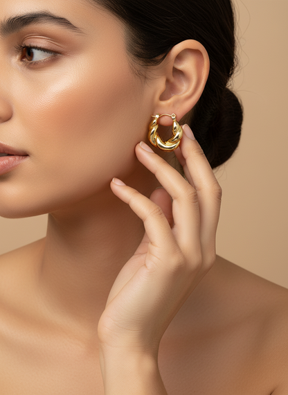 Gold hoop earrings on a white background