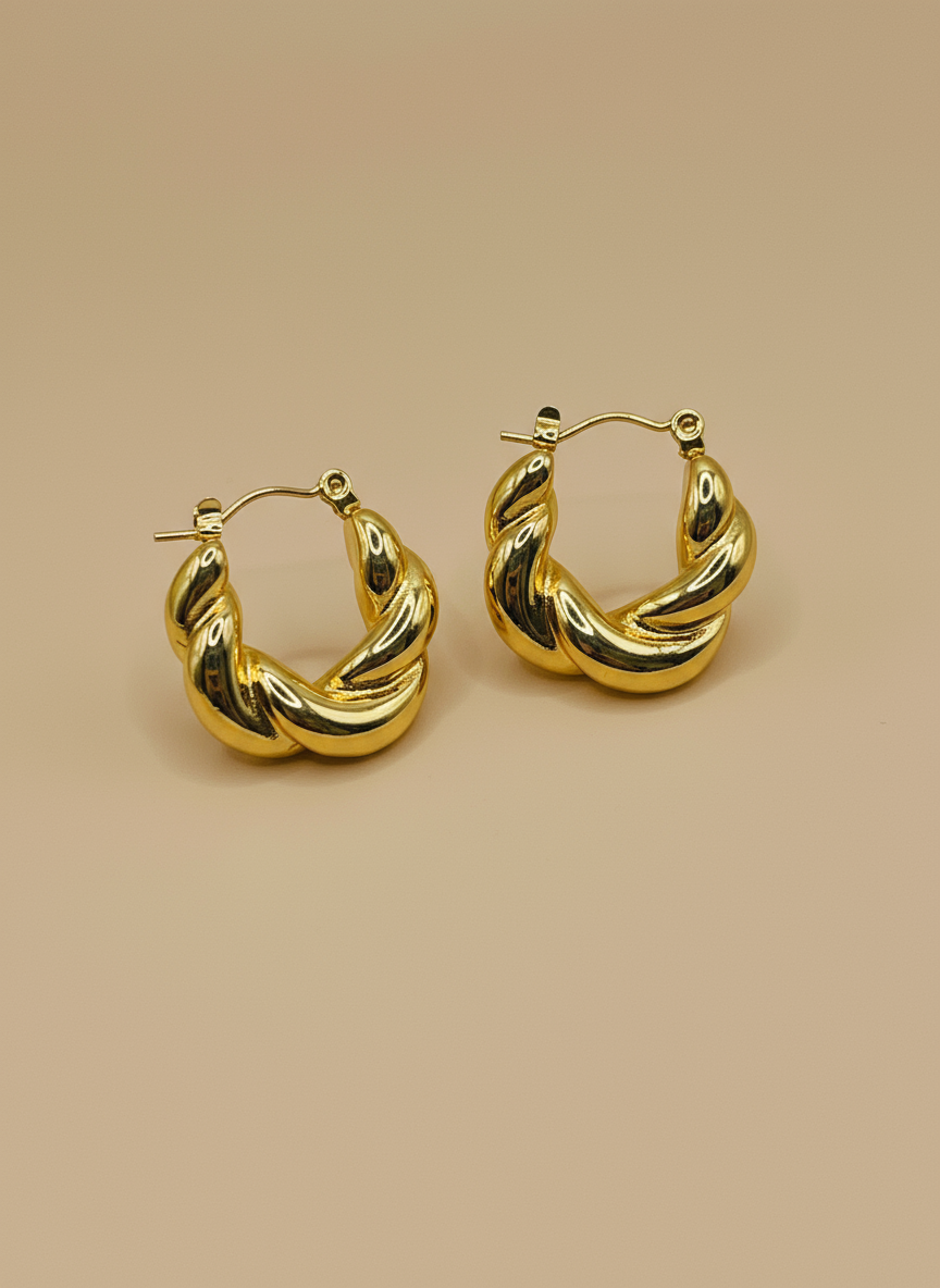 Gold hoop earrings on a white background