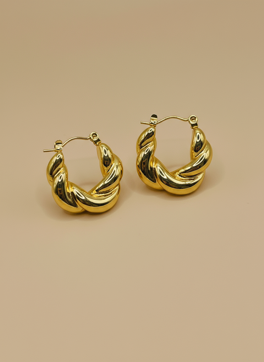 Gold hoop earrings on a white background