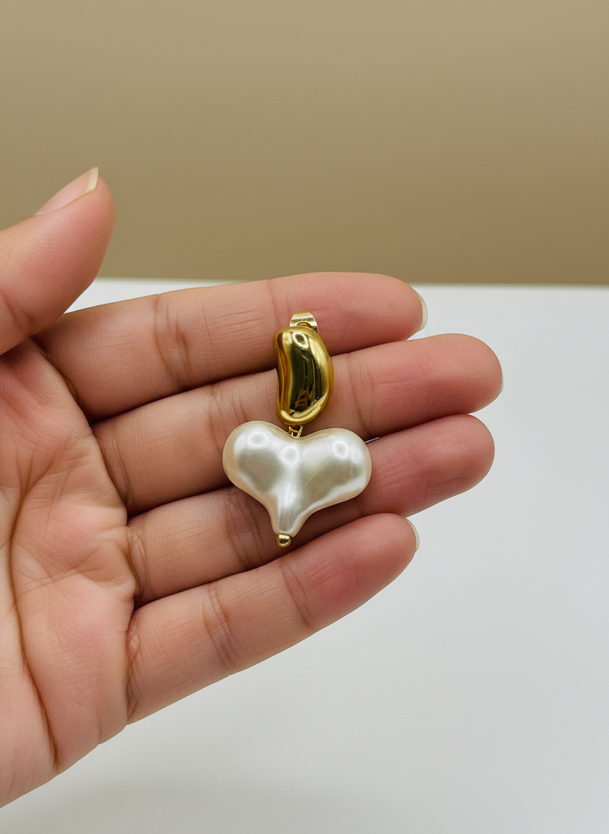 Pearl earrings with gold accents on a white surface