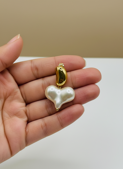 Pearl earrings with gold accents on a white surface