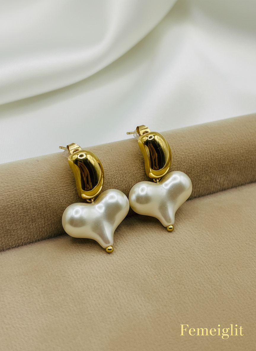 Pearl earrings with gold accents on a white surface